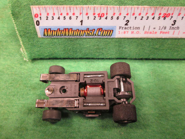 Bottom view of Aurora AFX G-Plus Wide Snap-In Axle Slot Car Chassis