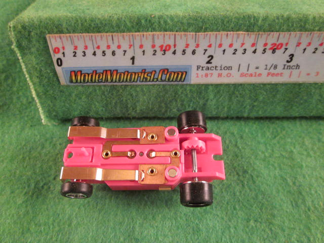 Bottom view of Dash Mondo Grip Pink HO Slot Car Chassis