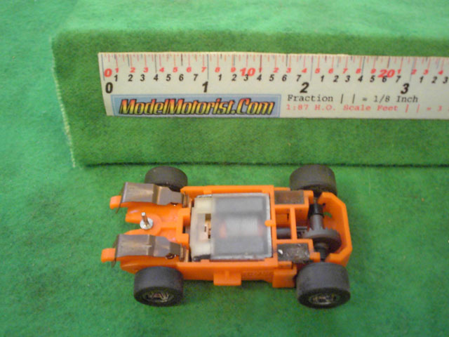 Bottom view of MR1 Racing Orange HO Slot Car Chassis